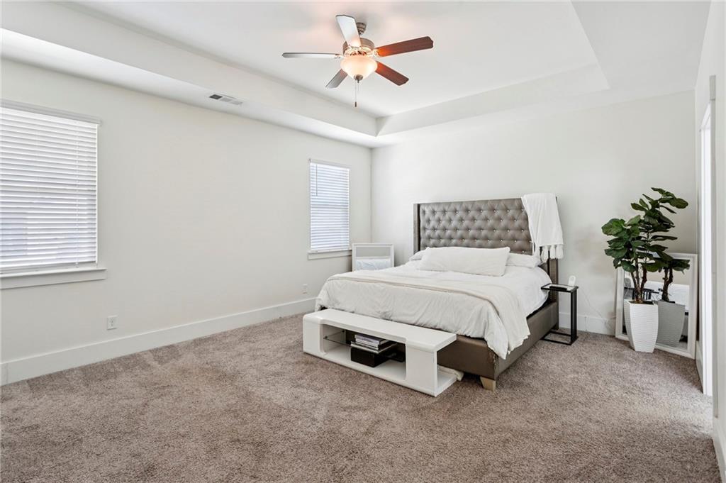 4006 Glendianne Way Powder Springs, GA 30127 - Photo 10 of 21 a spacious bedroom with a bed and a chandelier