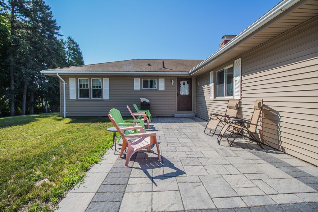 a view of a house with backyard sitting area and garden