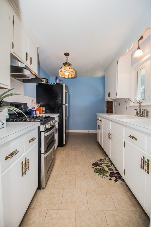 14 Governors Street Worcester, MA 01606 - Photo 11 of 26 a kitchen with a sink a stove and cabinets