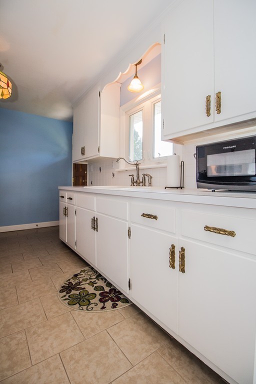 14 Governors Street Worcester, MA 01606 - Photo 13 of 26 a kitchen with a sink stove and cabinets