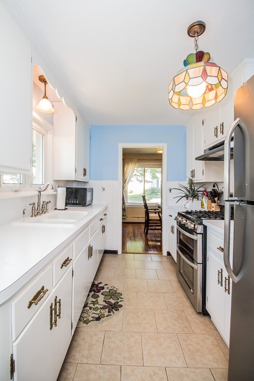 14 Governors Street Worcester, MA 01606 - Photo 14 of 26 a large white kitchen with a stove top oven