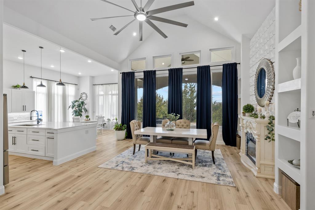 a living room with furniture large window and wooden floor