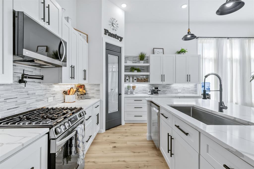 971 Sister Grove Road Van Alstyne, TX 75495 - Photo 11 of 38 a kitchen with stainless steel appliances granite countertop a sink stove and refrigerator