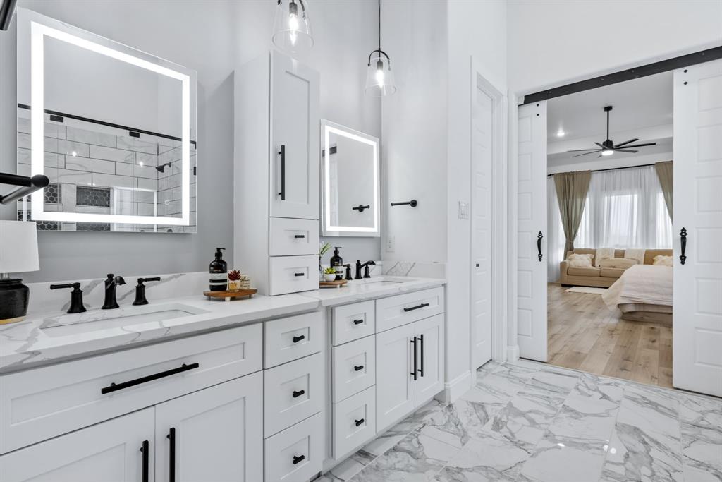 971 Sister Grove Road Van Alstyne, TX 75495 - Photo 17 of 38 a spacious bathroom with a granite countertop sink mirror and a