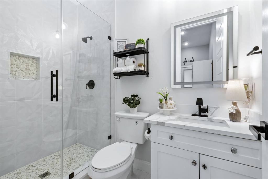 971 Sister Grove Road Van Alstyne, TX 75495 - Photo 23 of 38 a bathroom with a granite countertop toilet sink and shower
