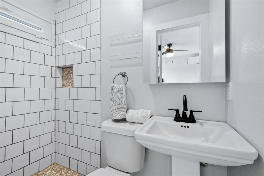 971 Sister Grove Road Van Alstyne, TX 75495 - Photo 31 of 38 a bathroom with a sink a toilet and mirror