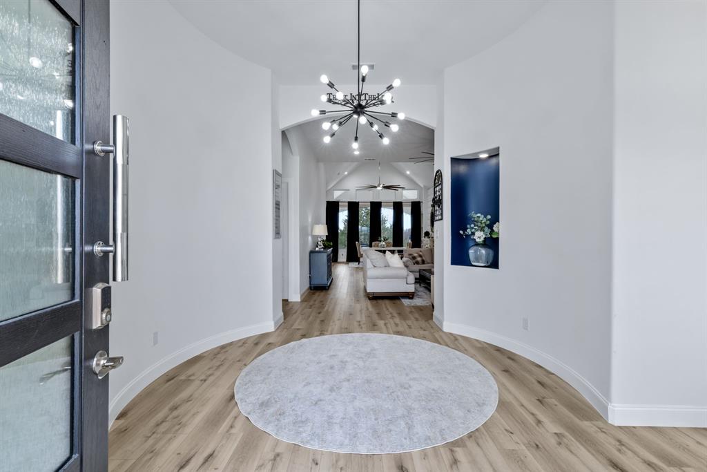 971 Sister Grove Road Van Alstyne, TX 75495 - Photo 8 of 38 an entryway and dining room with wooden floor