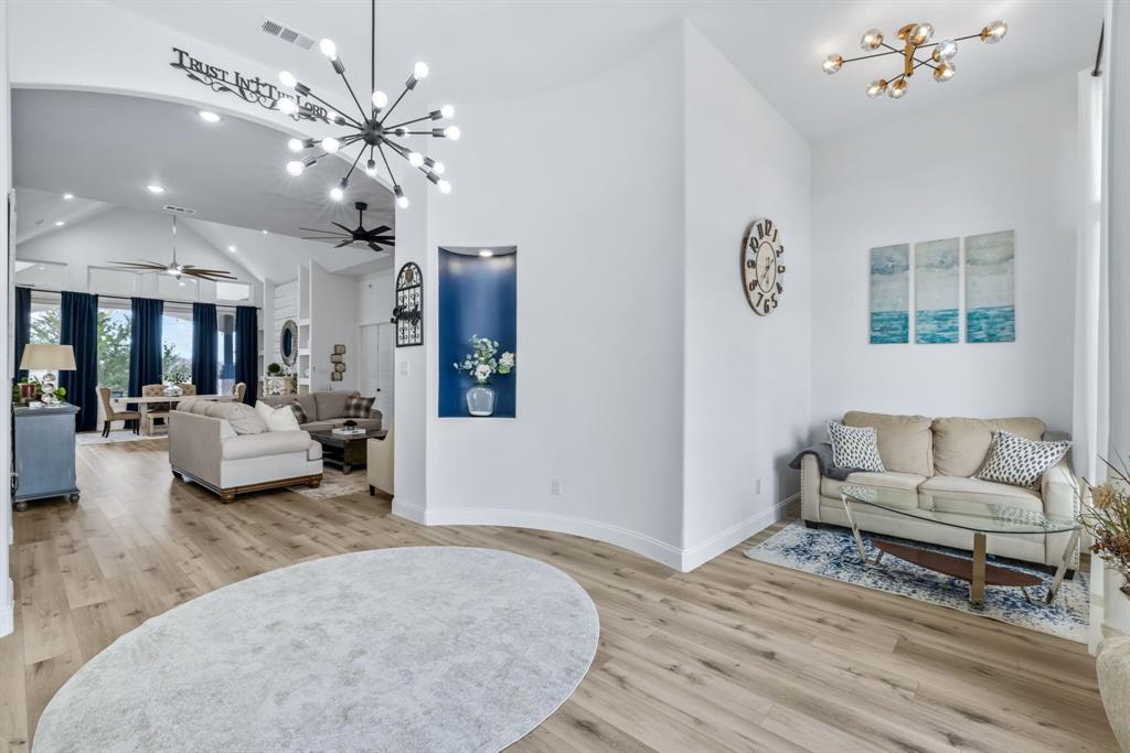 971 Sister Grove Road Van Alstyne, TX 75495 - Photo 9 of 38 a living room with furniture and a chandelier