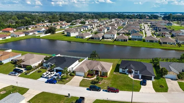 an aerial view of a house with a swimming pool outdoor seating and yard