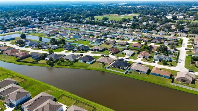 an aerial view of residential houses with outdoor space