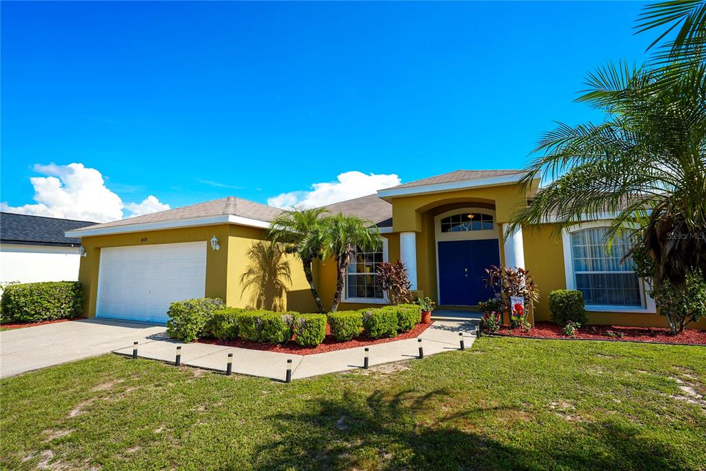 1070 Summer Glen Drive Winter Haven, FL 33880 - Photo 2 of 40 a view of a house with potted plants and a large tree