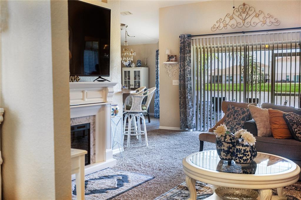 1070 Summer Glen Drive Winter Haven, FL 33880 - Photo 22 of 40 a living room with furniture a fireplace and a flat screen tv