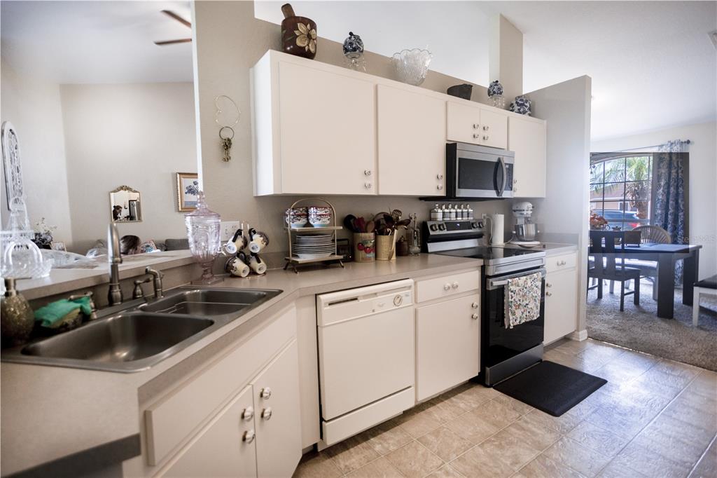 1070 Summer Glen Drive Winter Haven, FL 33880 - Photo 24 of 40 a kitchen with stainless steel appliances granite countertop a sink a stove and cabinets
