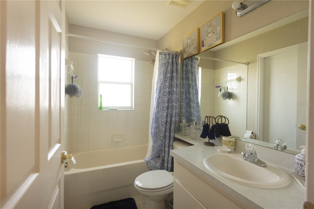 1070 Summer Glen Drive Winter Haven, FL 33880 - Photo 25 of 40 a bathroom with a toilet a sink a mirror a bathtub and shower