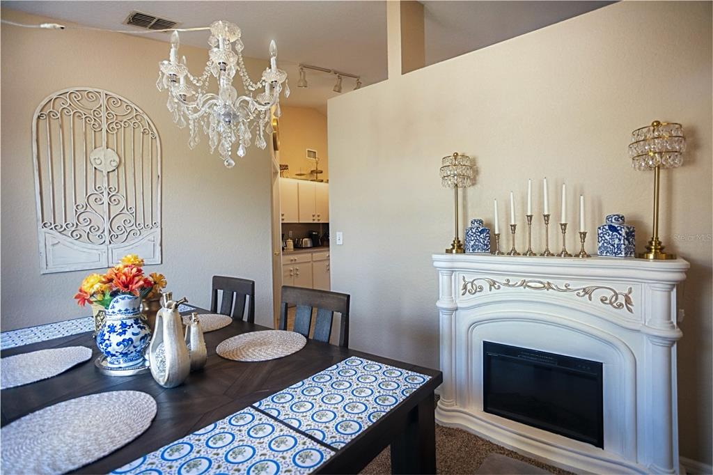 1070 Summer Glen Drive Winter Haven, FL 33880 - Photo 27 of 40 a living room with furniture a chandelier and a fireplace
