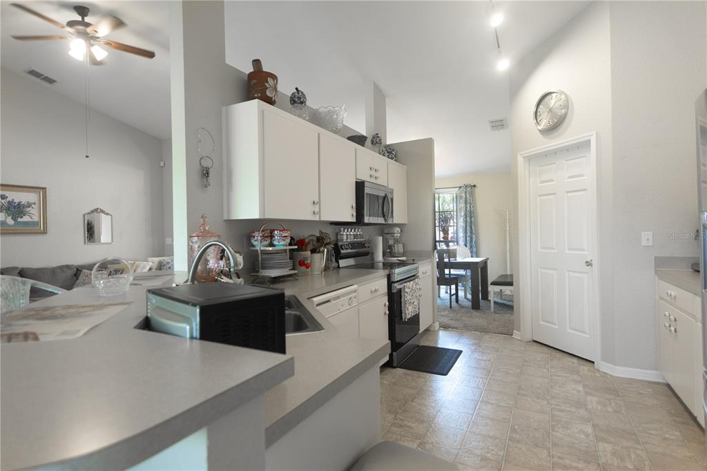 1070 Summer Glen Drive Winter Haven, FL 33880 - Photo 29 of 40 a kitchen with stainless steel appliances kitchen island granite countertop a stove and white cabinets