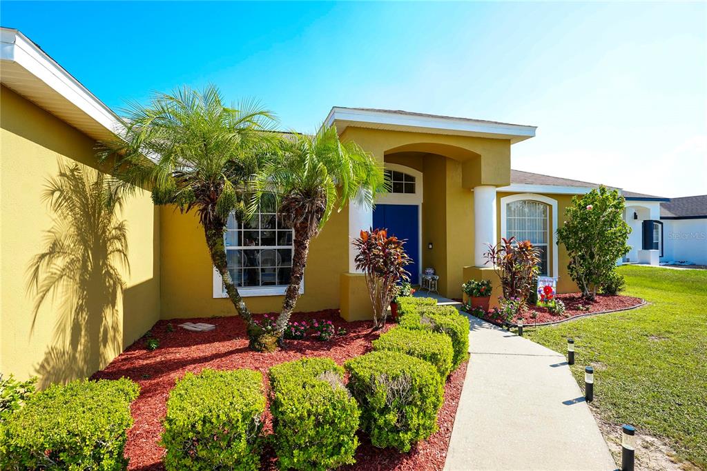 1070 Summer Glen Drive Winter Haven, FL 33880 - Photo 3 of 40 a front view of a house with a yard