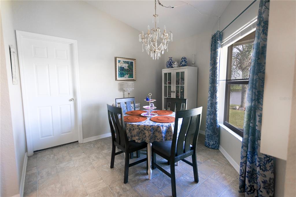 1070 Summer Glen Drive Winter Haven, FL 33880 - Photo 33 of 40 a view of a dining room with furniture and chandelier