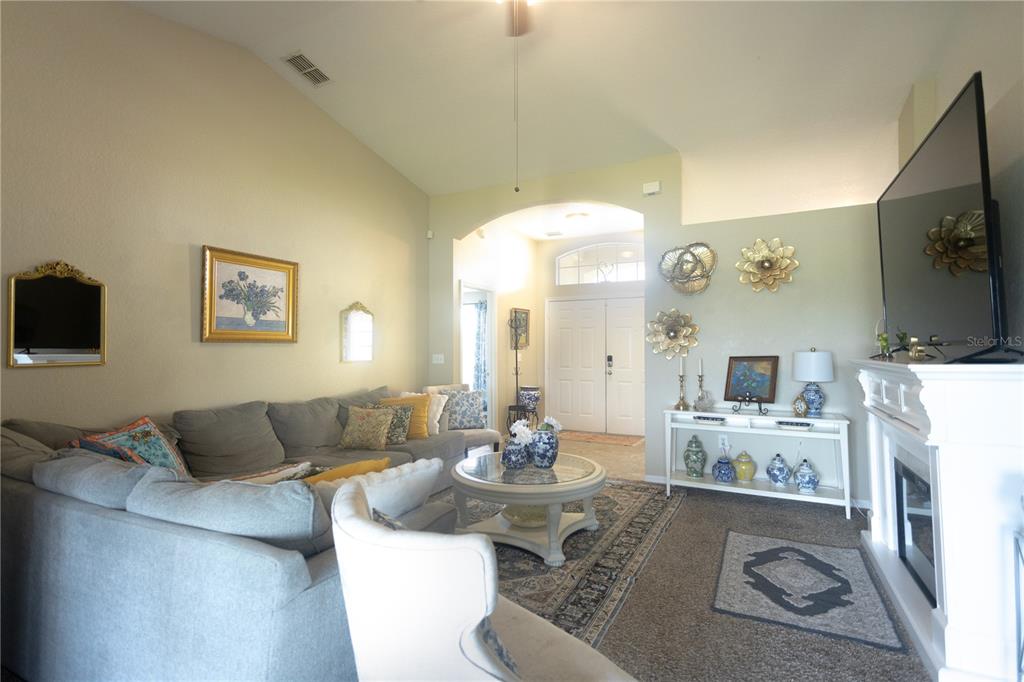 1070 Summer Glen Drive Winter Haven, FL 33880 - Photo 37 of 40 a living room with furniture a flat screen tv and kitchen view