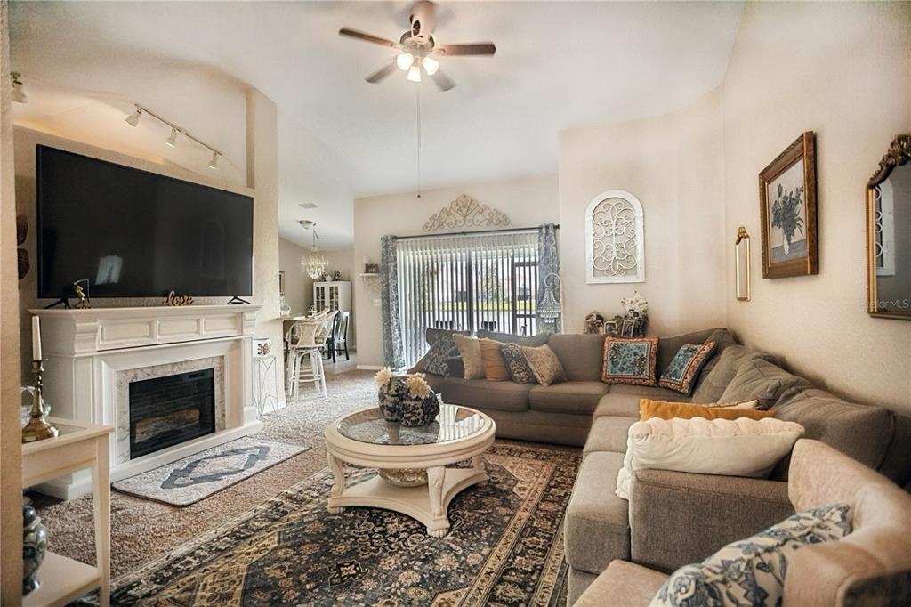 1070 Summer Glen Drive Winter Haven, FL 33880 - Photo 38 of 40 a living room with furniture a fireplace and a flat screen tv