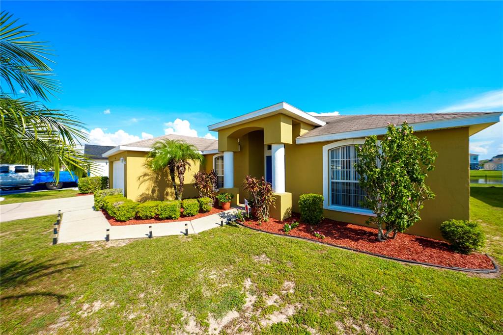 1070 Summer Glen Drive Winter Haven, FL 33880 - Photo 6 of 40 a front view of a house with a yard fountain