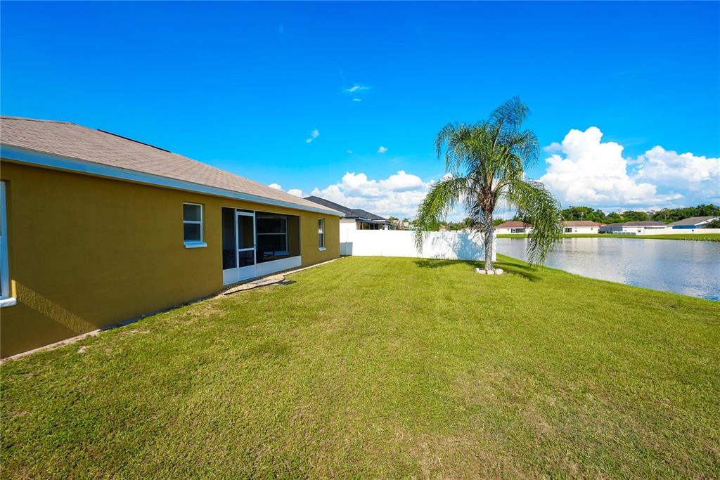 1070 Summer Glen Drive Winter Haven, FL 33880 - Photo 8 of 40 a view of a house with swimming pool and a yard
