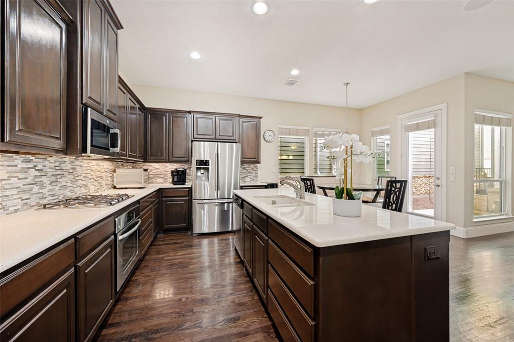 773 South Coppell Road Coppell, TX 75019 - Photo 9 of 30 a large kitchen with stainless steel appliances granite countertop a sink stove and refrigerator