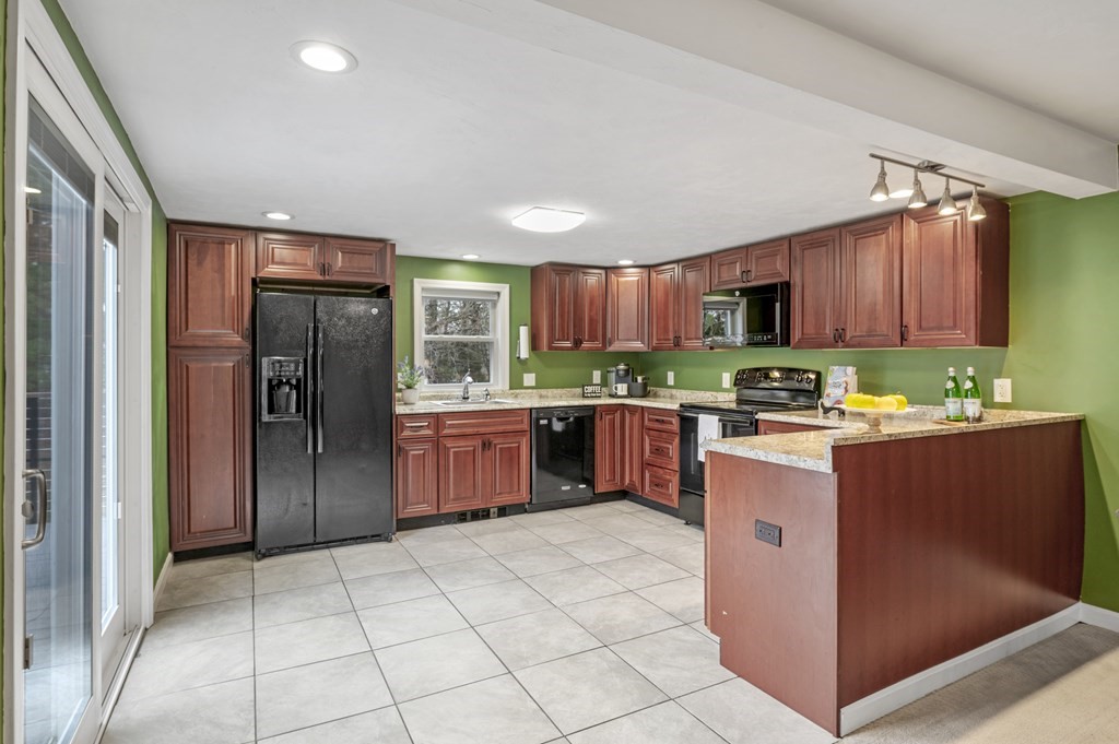 26 Temple Drive Methuen, MA 01844 - Photo 11 of 38 a kitchen with stainless steel appliances granite countertop a refrigerator and a sink