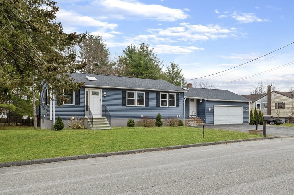 26 Temple Drive Methuen, MA 01844 - Photo 2 of 38 a front view of a house with a yard and trees