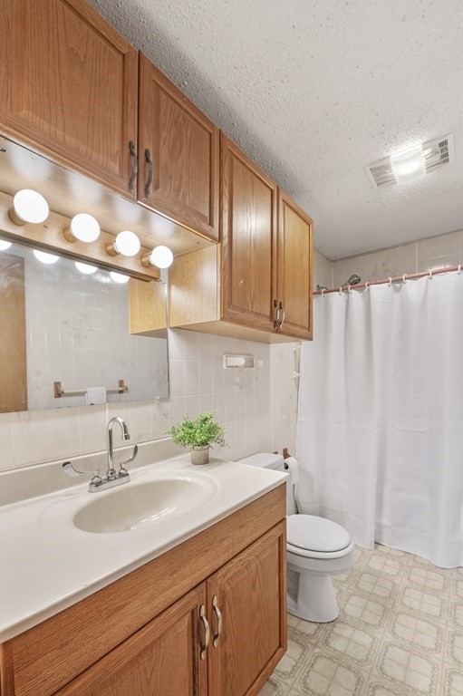 26 Temple Drive Methuen, MA 01844 - Photo 32 of 38 a bathroom with a sink a toilet and shower