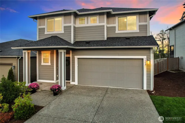a front view of a house with a yard and garage