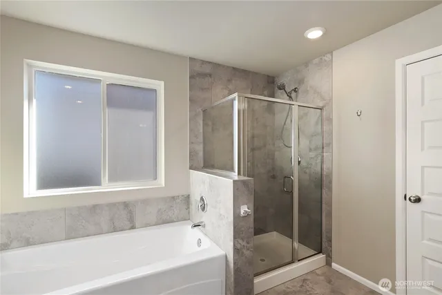 a bathroom with a bathtub and a shower