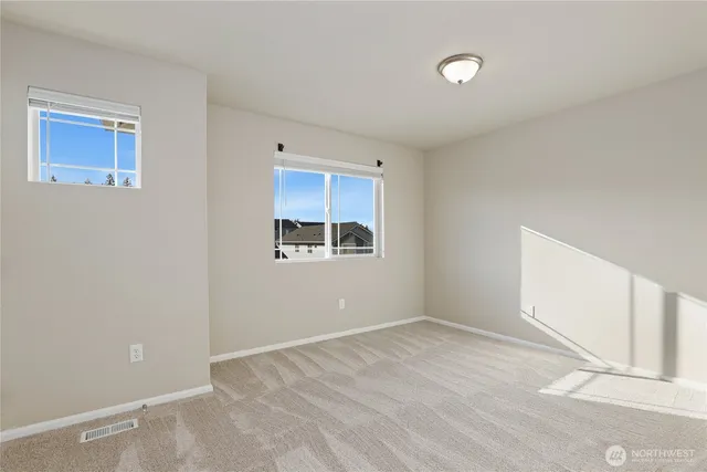 a view of a livingroom with wooden & cabinets