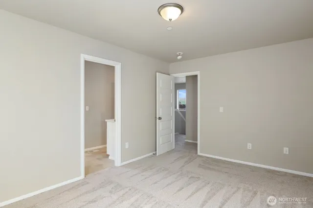 an empty room with wooden floor and mirror