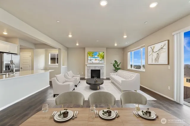 a living room with furniture a fireplace and wooden floor