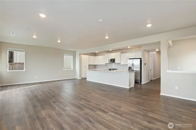 a view of a kitchen with a sink refrigerator and window