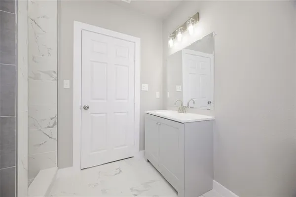 a bathroom with a sink a mirror and a shower