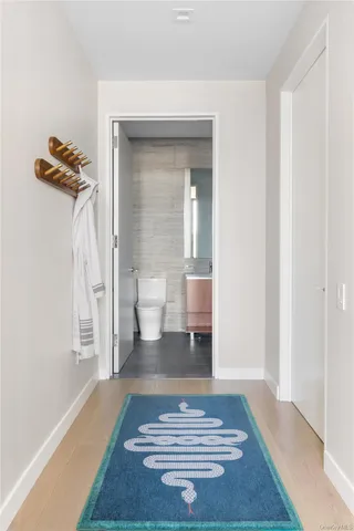 a bathroom with a double vanity sink toilet mirror and bathtub