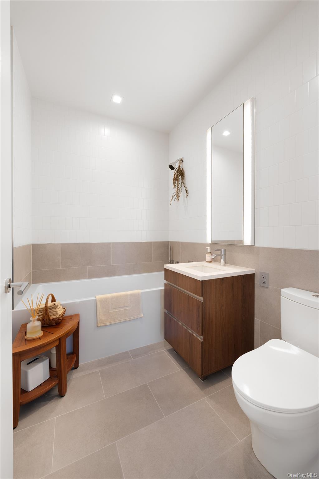 21-21 31st Street, Unit 4E Queens, NY 11105 - Photo 18 of 25 a bathroom with a bathtub sink and toilet