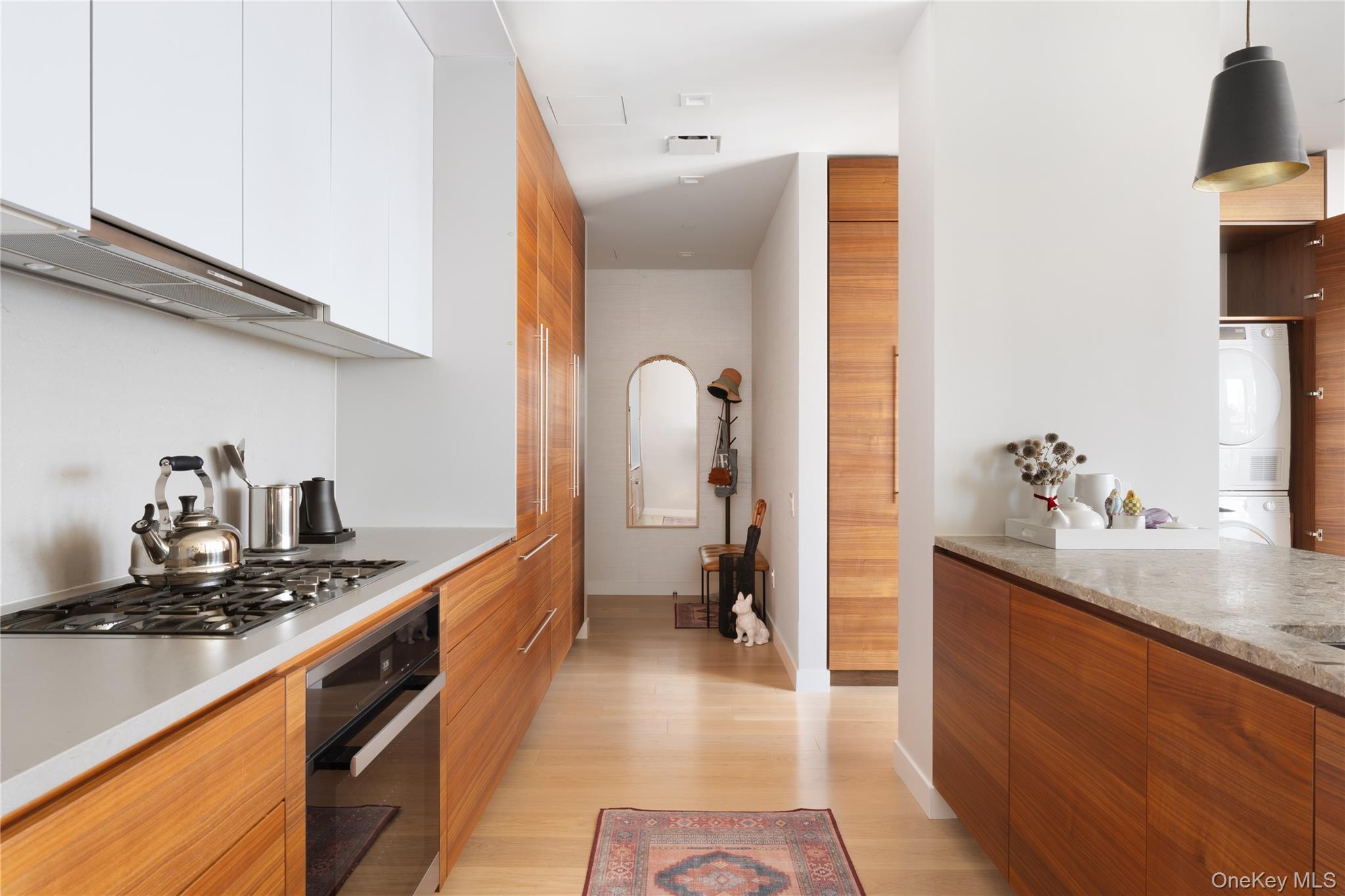 21-21 31st Street, Unit 4E Queens, NY 11105 - Photo 9 of 25 a kitchen with sink stove and cabinets