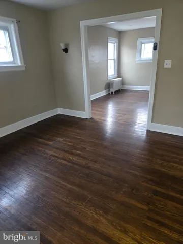 a view of a livingroom with wooden floor and window