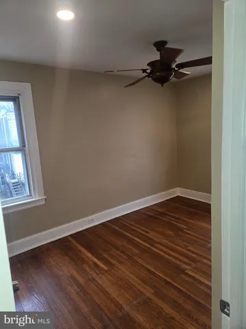 a view of a room with wooden floor and window
