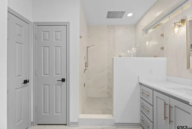 a bathroom with a shower and a sink