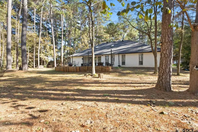 a view of a house with a large tree