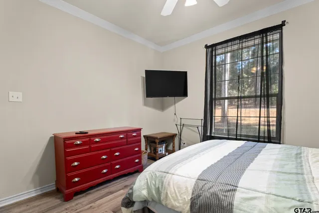a bedroom with a bed and a flat screen tv