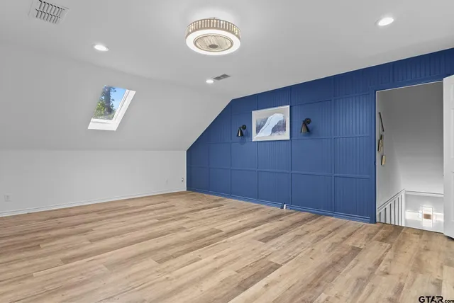 a room with a bed and a chandelier