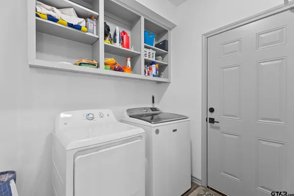 a view of walk in closet with wooden floor
