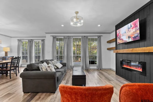 a living room with furniture fireplace and flat screen tv