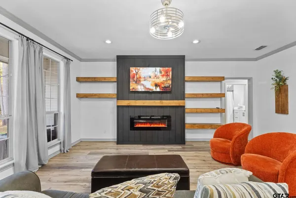 a living room with furniture a rug and a fireplace