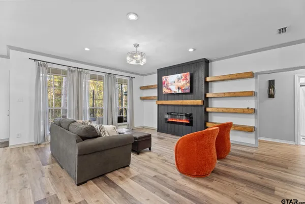 a living room with furniture and a fireplace